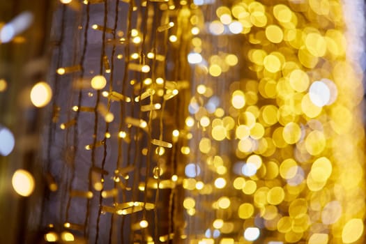 Festive background with LED lights garland. Christmas and New Year background. Blurred bokeh from the lights of a garland.
