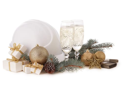 Construction hard hat, fir tree branches, two glasses with champagne, gift boxes and Christmas ornament isolated on a white background. New Year and Christmas construction background