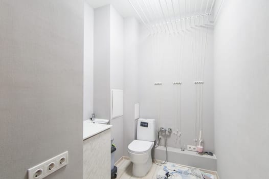 Russia, Moscow- May 20, 2019: interior room apartment. standard repair decoration in hostel. modern bathroom, sink, decoration elements, toilet.