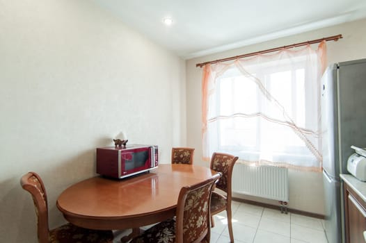 Russia, Moscow- May 20, 2019: interior room apartment. standard repair decoration in hostel. modern kitchen, dining area