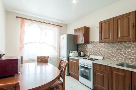 Russia, Moscow- May 20, 2019: interior room apartment. standard repair decoration in hostel. modern kitchen, dining area