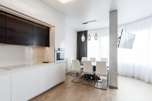 Russia, Moscow- May 20, 2019: interior room apartment. standard repair decoration in hostel. modern kitchen, dining area