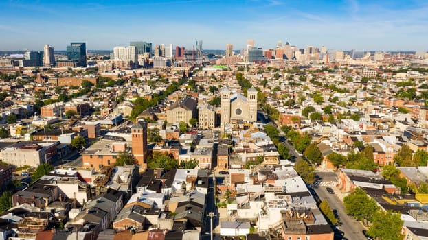 Row houses churches parks and businesses exhist in the expansive city of Baltimore
