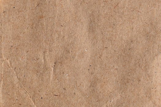 Brown paper with fibers and crease abstract background texture.