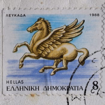 GREECE - CIRCA 1988: Pegasus flying horse greek mythology winged creature illustration on vintage postage stamp printed and postmarked by the Hellenic Post.