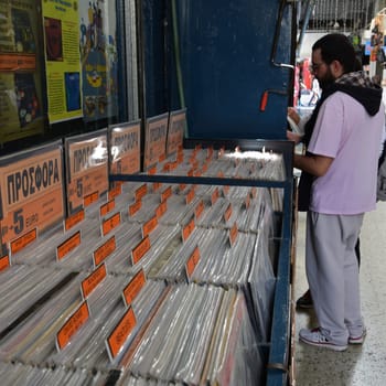 ATHENS, GREECE - APRIL 27, 2015: People browsing through the rock music section at used vinyl record store.