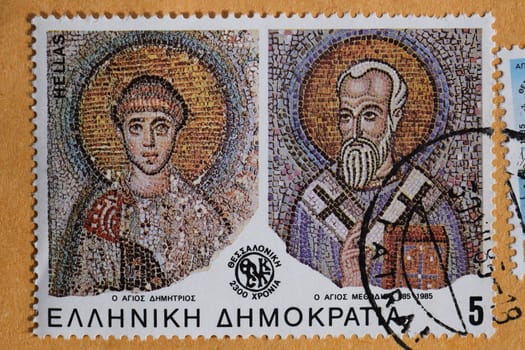 GREECE - CIRCA 1985: Saints Demetrius and Methodius of Thessaloniki detail from byzantine era mosaic on vintage postage stamp printed by the Hellenic Post.