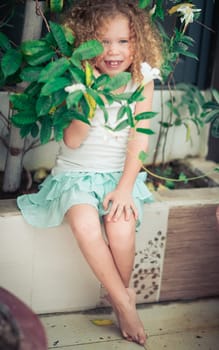 Portrait of a cute girl sitting ouddoor