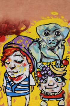 ATHENS, GREECE - APRIL 27, 2015: Abstract graffiti monkey with fruit and two cartoon characters. Colorful urban street art.