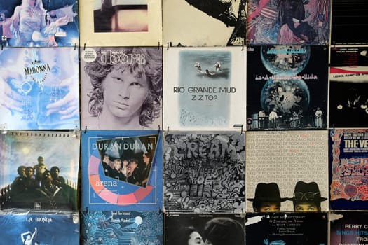ATHENS, GREECE - APRIL 24, 2015: Old faded vinyl records pop and rock music vintage album sleeves background.