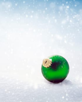 Christmas green ball on white snow background