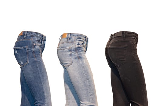 Set jeans isolated. Side view of a collection of three various denim pants on a ghost mannequin isolated on a white background. Advertising jeans shop. Jeans fashion.