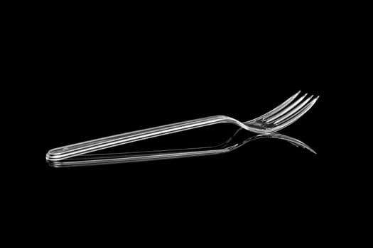 Transparent plastic fork isolated on black background. With clipping path
