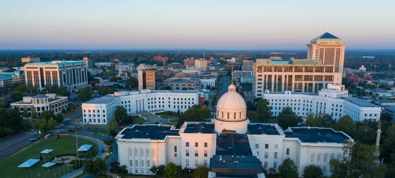 Golden sunlight reaches the horizon showing around the capital statehouse in Montgomery Alabama