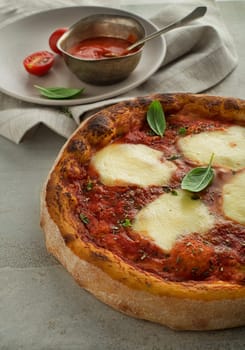 Pizza Margherita served with mozzarella cheese, tomato sauce and fresh basil