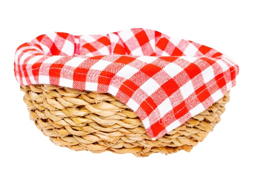 Empty picnic basket. Close-up of a empty straw basket therein a red checkered napkin isolated on a white background. For your food and product display montage. Macro.
