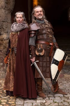 Couple posing robed in beautiful medieval clothing