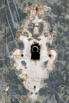 Detail of the keyhole in the old damaged door