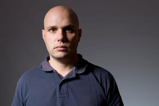 Portrait of young man thinking on a black background
