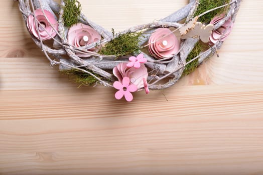 Beautiful spring ornamental wreath with butterflies and pink flowers of wood