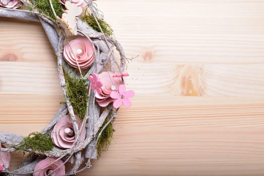 Beautiful spring ornamental wreath with butterflies and pink flowers of wood