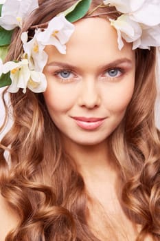 Charming girl with fresh flowers in hair