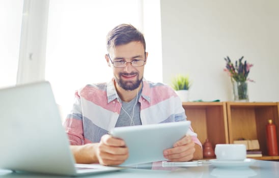 Businessman in casual working with modern gadgets in office