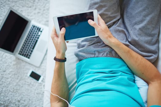 Young man using digital tablet at leisure