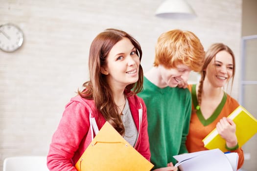 Group of students in casualwear sitting in classroom
