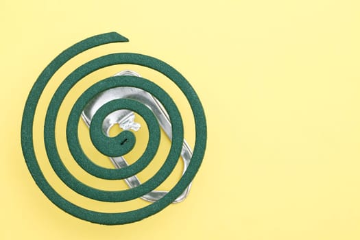 green mosquito spiral on yellow background