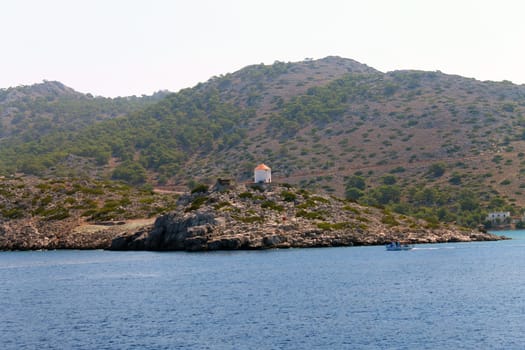 The lonely windmill on the coastline in Greece