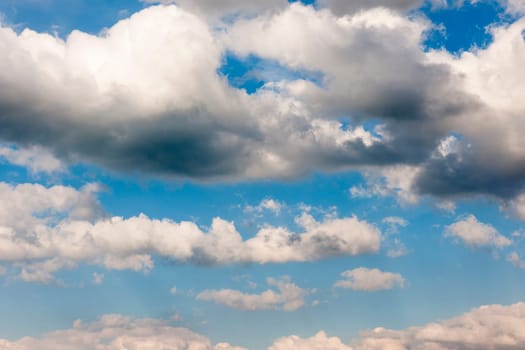 Blue sky with three layered cloud bands. Clouds.