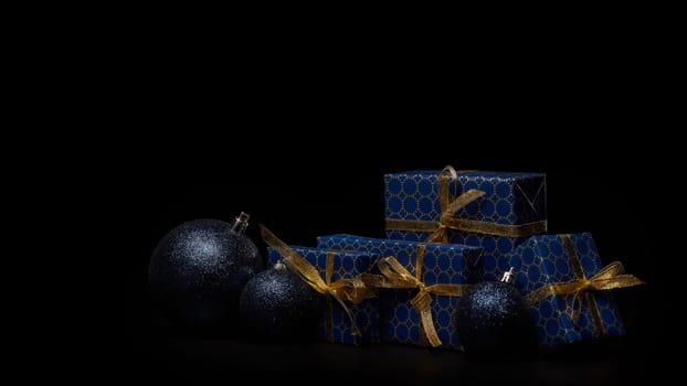 Gift boxes, Christmas decoration on black background with copy space. Christmas and New Year shopping. Greeting card