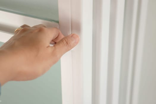 Hand on white door holder, stock photo