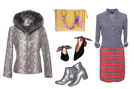 Collage woman clothes. Set of a stylish and trendy gray leather jacket with fur head, a dress, two pair shoes and a handbag isolated on a white background. Latest fashion trends.