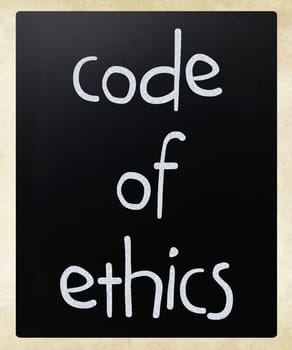 "Code of ethics"" handwritten with white chalk on a blackboard"