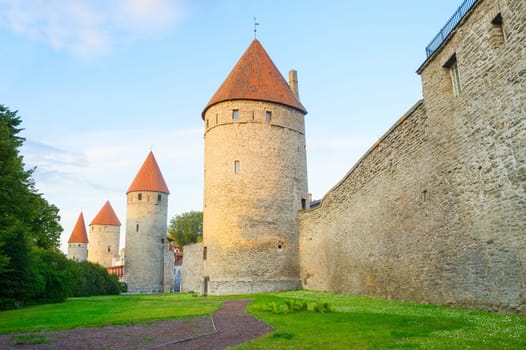 Fortress wall and towers of an Old Town of Tallin in sunset light. Estonia
