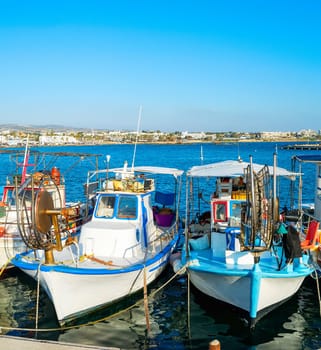 Typical colorful fishing boats moored in Paphos city harbor, sunlight, Cyprus
