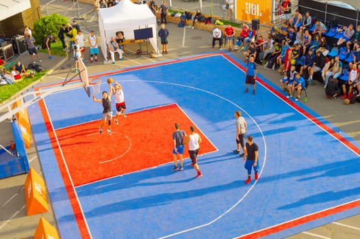KYIV, UKRAINE - SEPT 14, 2109: Men play basketball on a street. Street ball championship. Aerial view