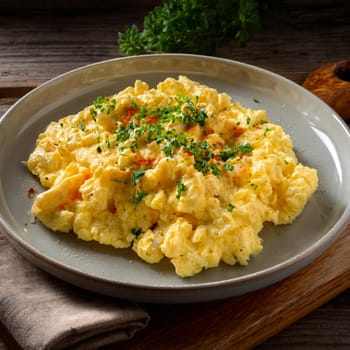 Oeuf Brouille features soft and fluffy scrambled eggs enhanced with butter and fresh herbs served warm for breakfast or brunch.