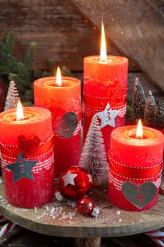 Colorful burning candles and festive decorations for Christmas