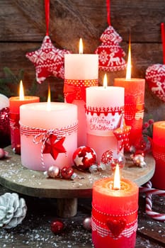 Colorful burning candles and festive decorations for Christmas
