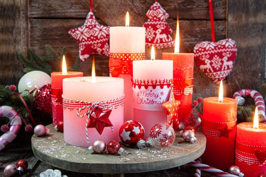 Colorful burning candles and festive decorations for Christmas