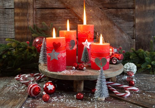 Colorful burning candles and festive decorations for Christmas