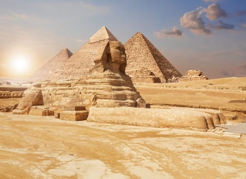 Famous Giza Sphinx and the Pyramids on the background, Egyptian desert.