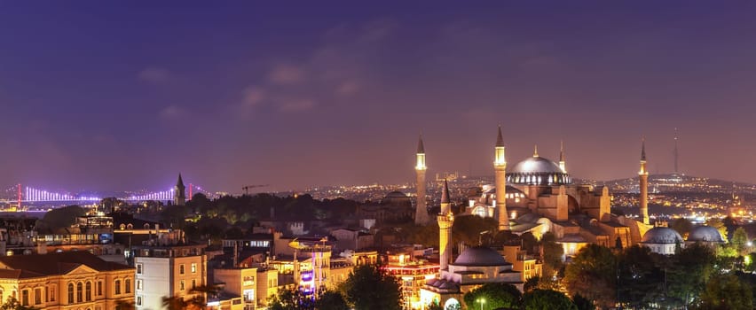 Hagia Sophia and the Bosphorus Bridge, evening panorama of Istanbul.