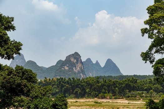 View of the unusual mountains in a light haze on a summer day, Yangshuo, China