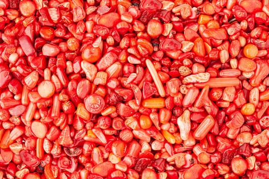 Small stones rounded red coral texture background