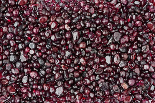 Small rounded garnet stones textured background