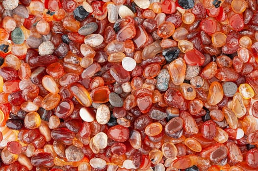 Small rounded red agate stones textured background